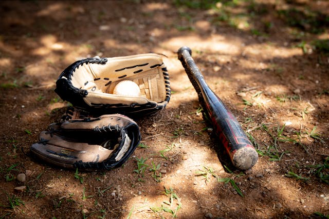 baseball equipment on the ground at sunset