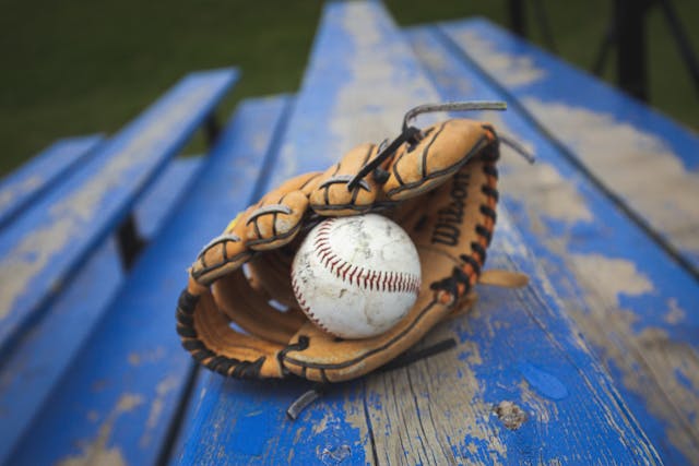 glove and baseball on blue bench